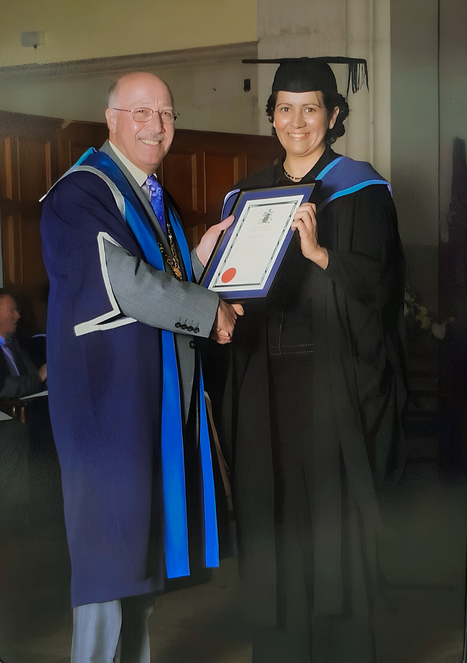 Madame Oukaci recevant son diplôme d'opticienne à Londres <img src='assets/angleterre.png' class='flag' alt='' aria-hidden='true' />.